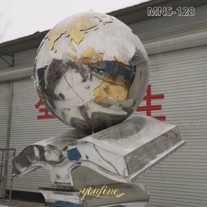 large metal globe sculpture with book