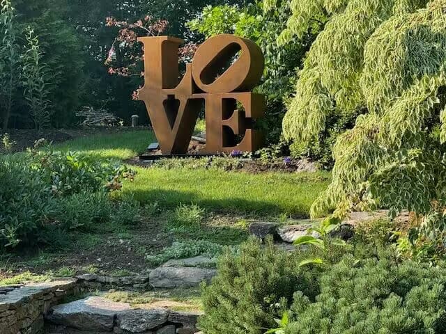 Corten steel Love sculpture installation in a USA city park