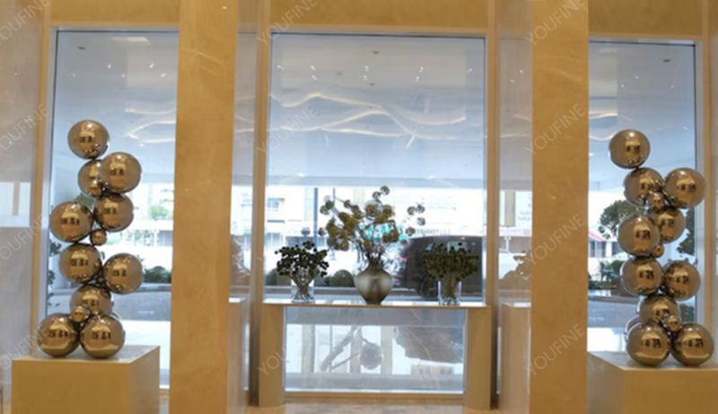 Stainless steel water feature sculpture in a luxury hotel lobby in Dubai