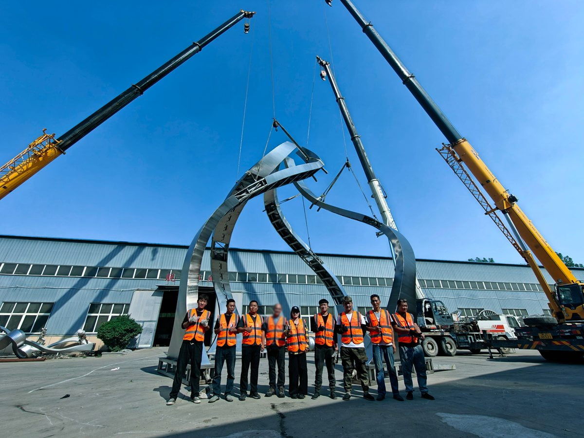 Engineers reviewing sculpture production quality at the factory